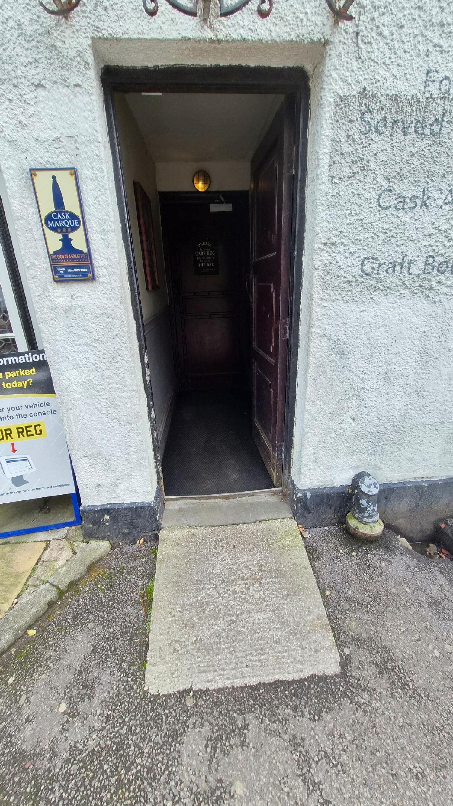 Dark wooden door. Use handle to open.
