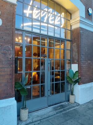 Grey metal-framed glass doors. Use handles to open.