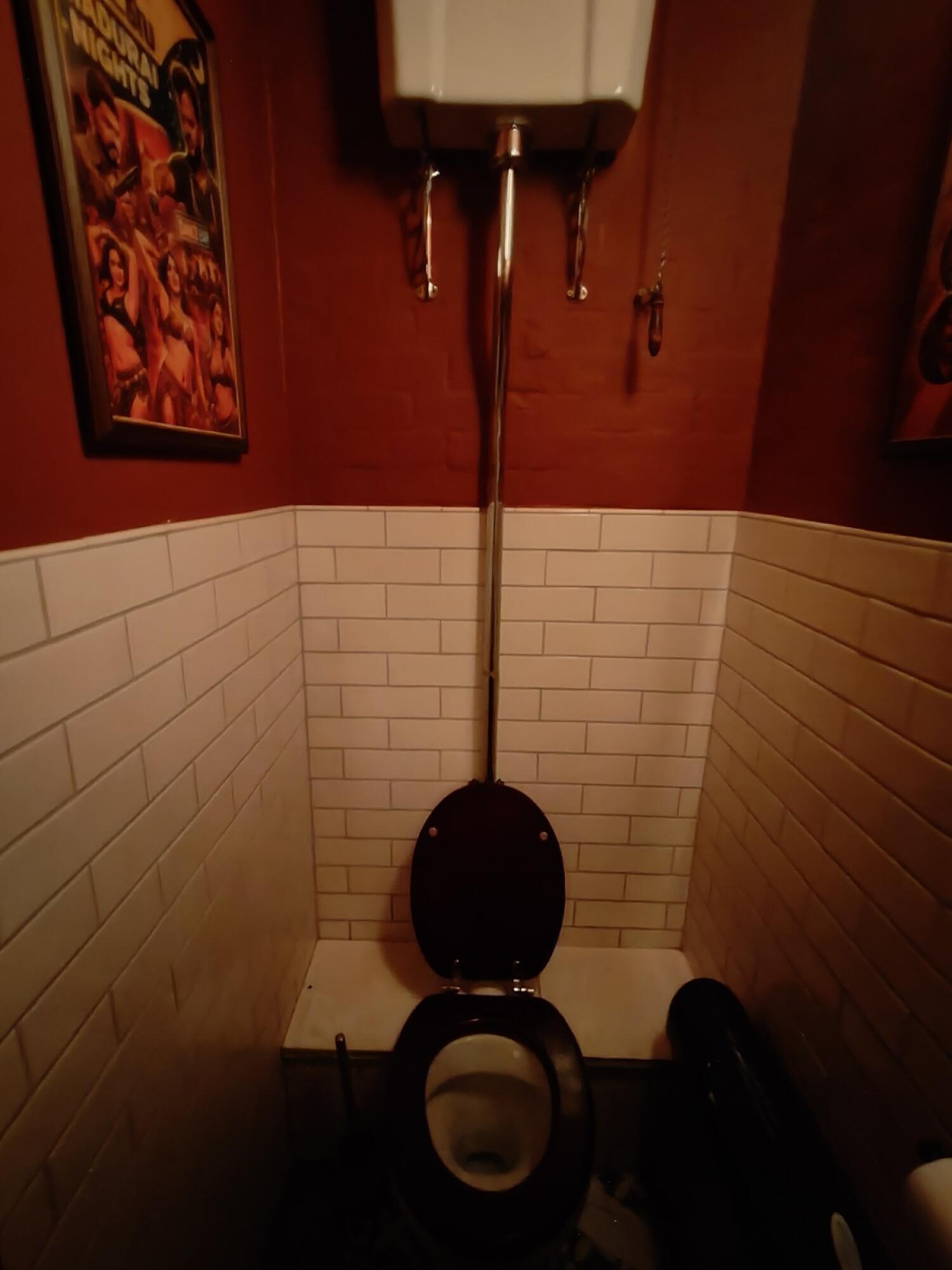 Toilet at back wall.