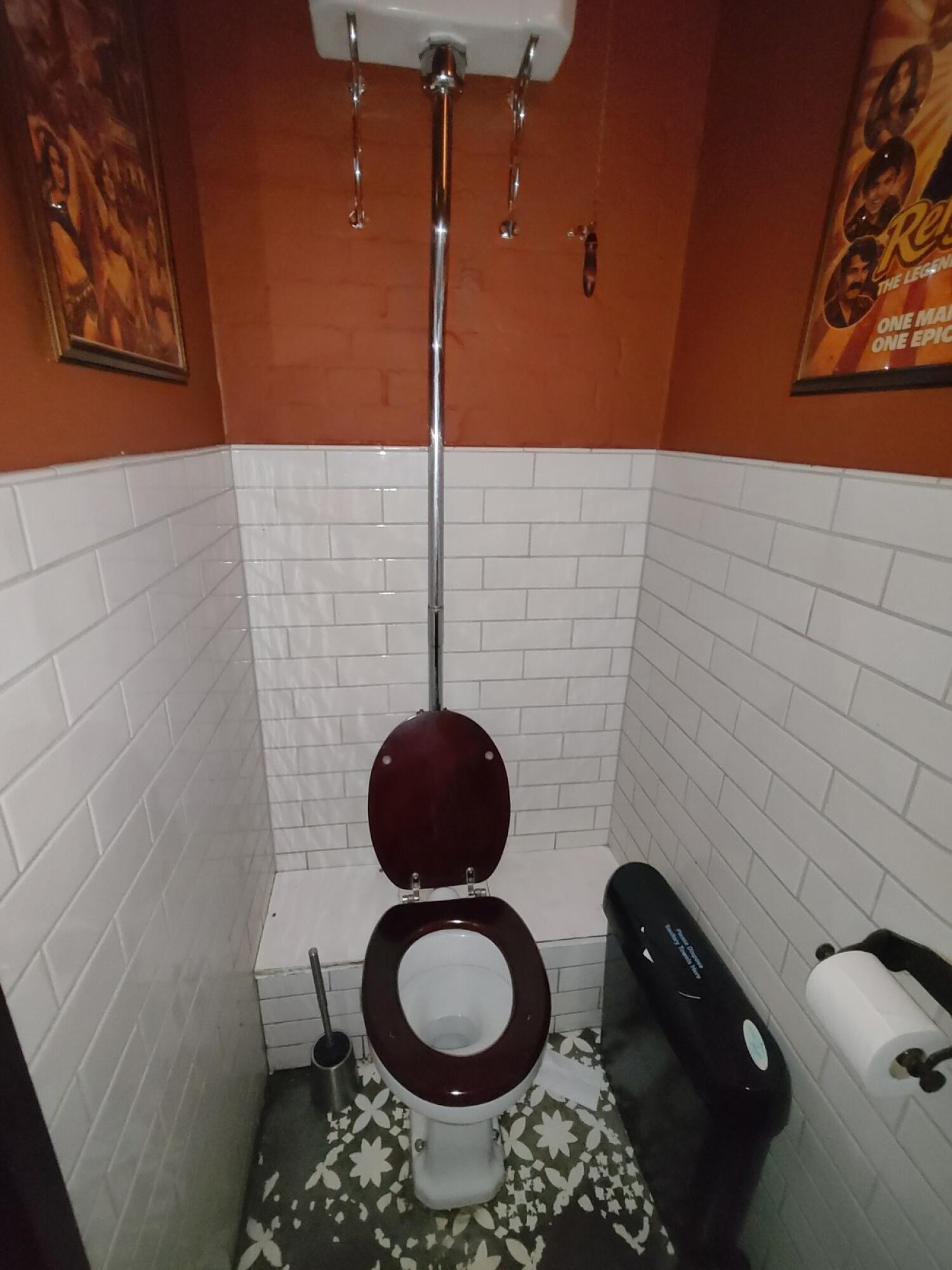Toilet in centre. Baby changing station on right.