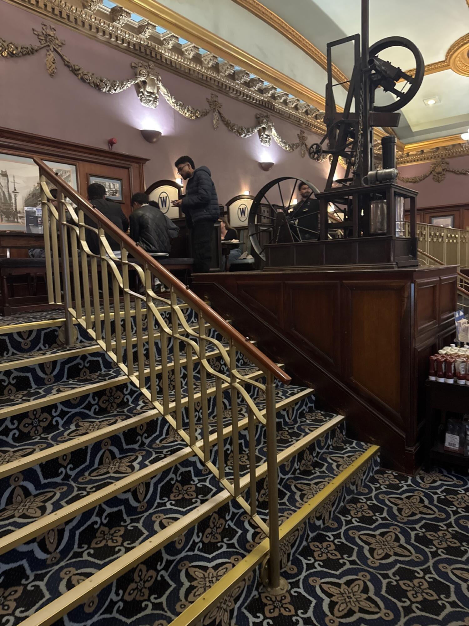 Staircase ahead. Handrails along left and right.