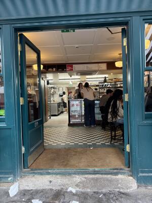 Teal wood-framed glass doors. Use handles to open.