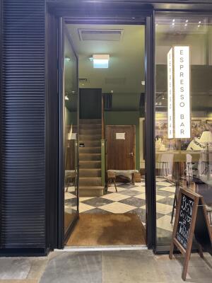 Black metal-framed glass door. Use handle to open.