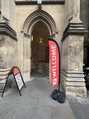 Stone archway with open wooden door.