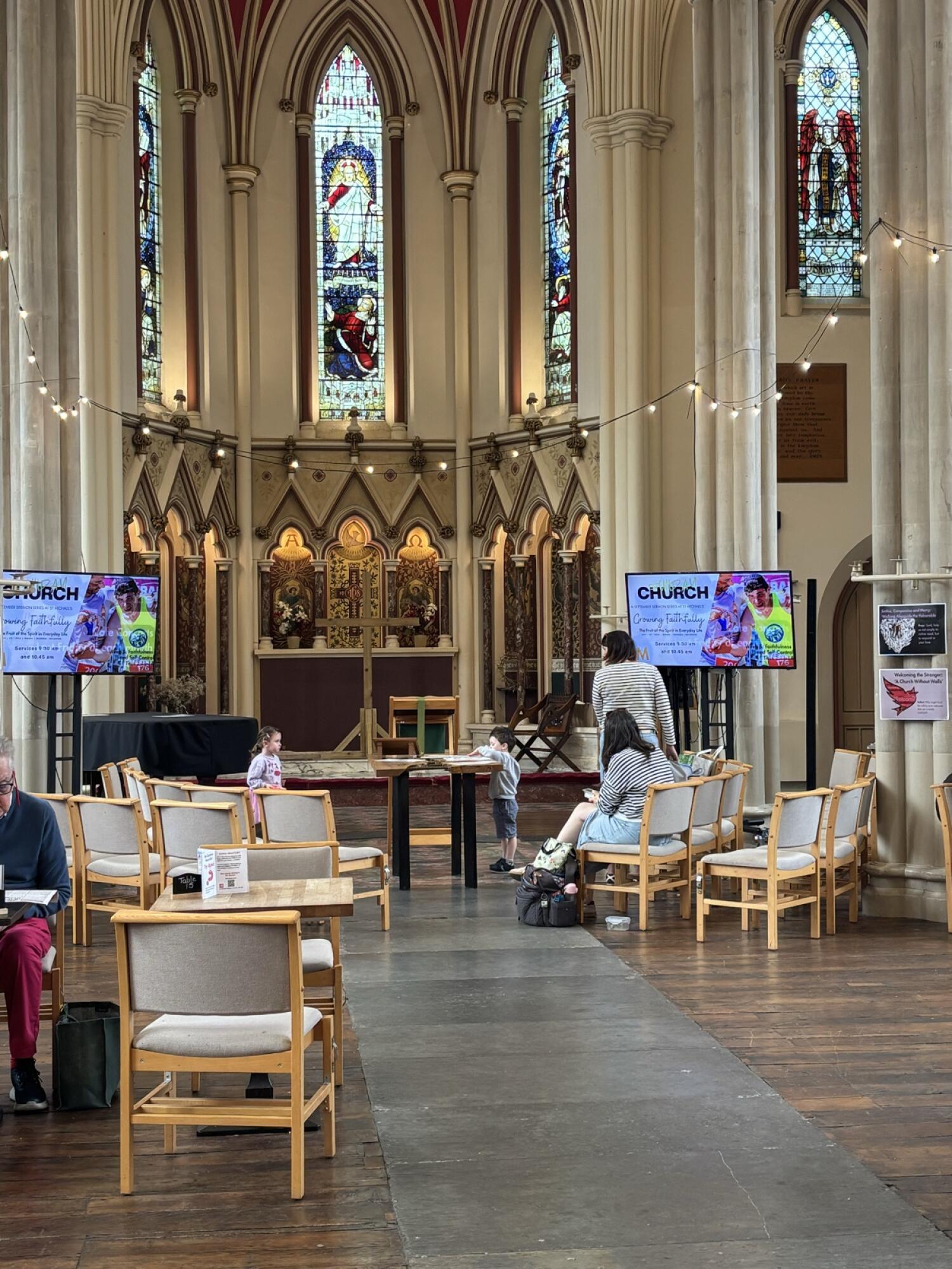 Tables and chairs along left. Stone path to altar centre. Chairs along right.
