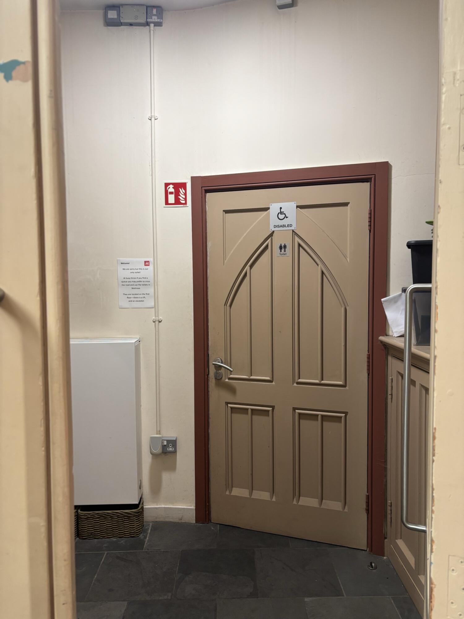 Brown wooden door. Use handle to open.