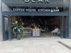 Doors run the width of left side of cafe. Counter on the left, main seating area on the right. Bifold doors, kept open during business hours.