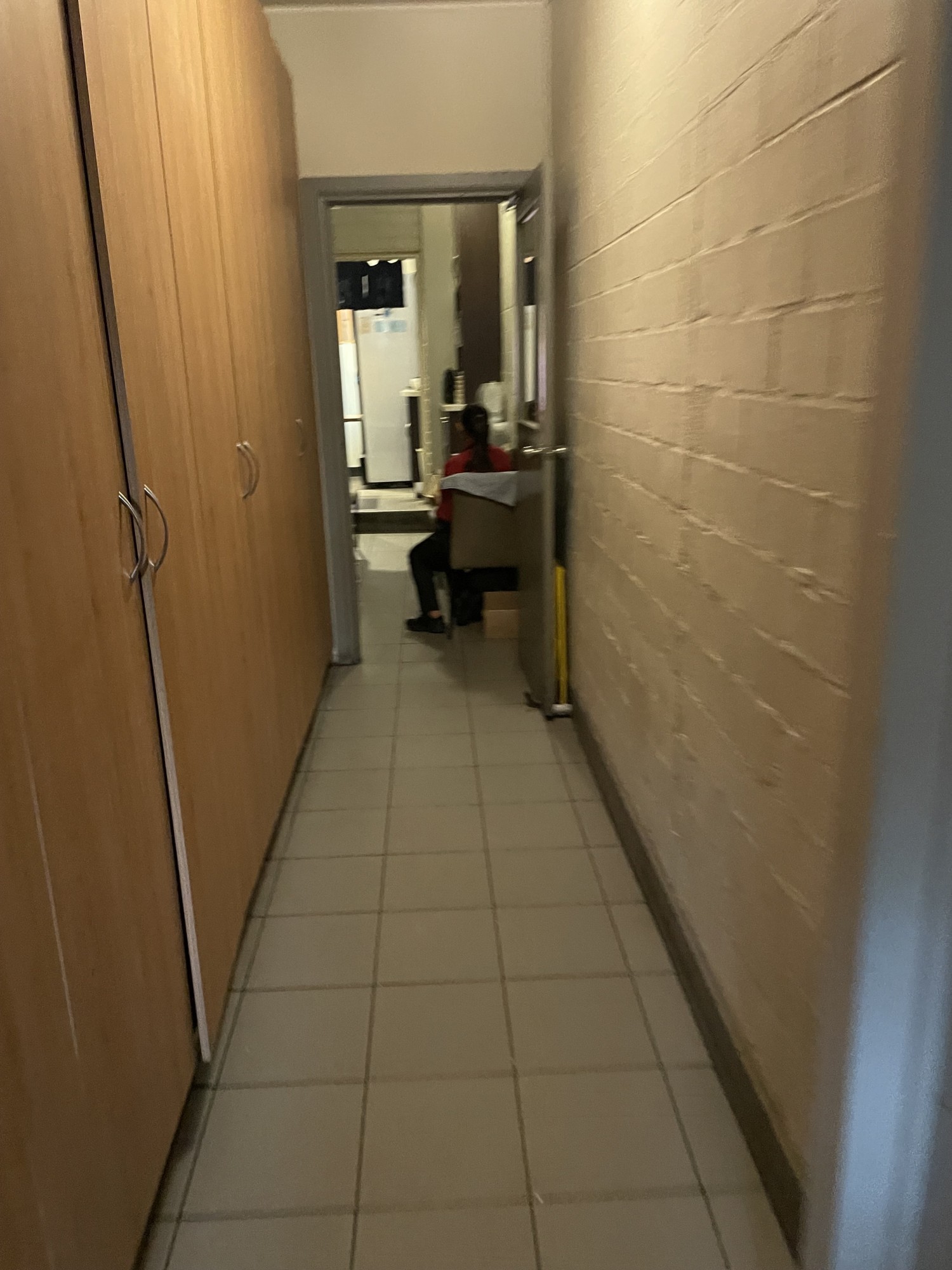 Step down to cluttered & obstructed pathway to bathroom