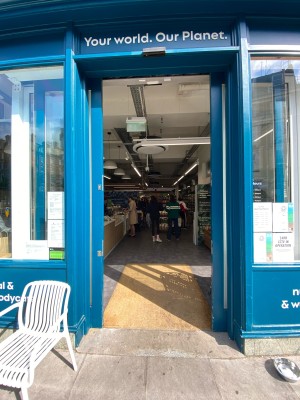 Glass door with blue frame ahead. Automatic opening