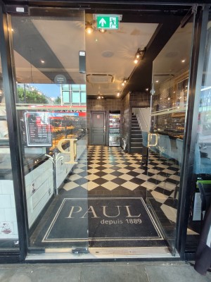 Black framed glass doors. Push golden handles in centre to open.