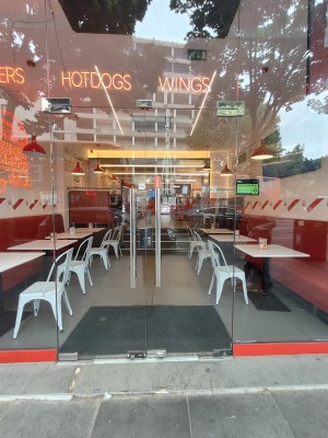 Glass doors. Push silver handles in centre to open.