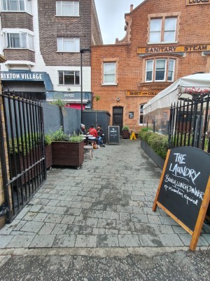 From pavement facing venue. Open gate ahead