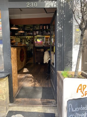 Glass door with wooden frame ahead. Open from right