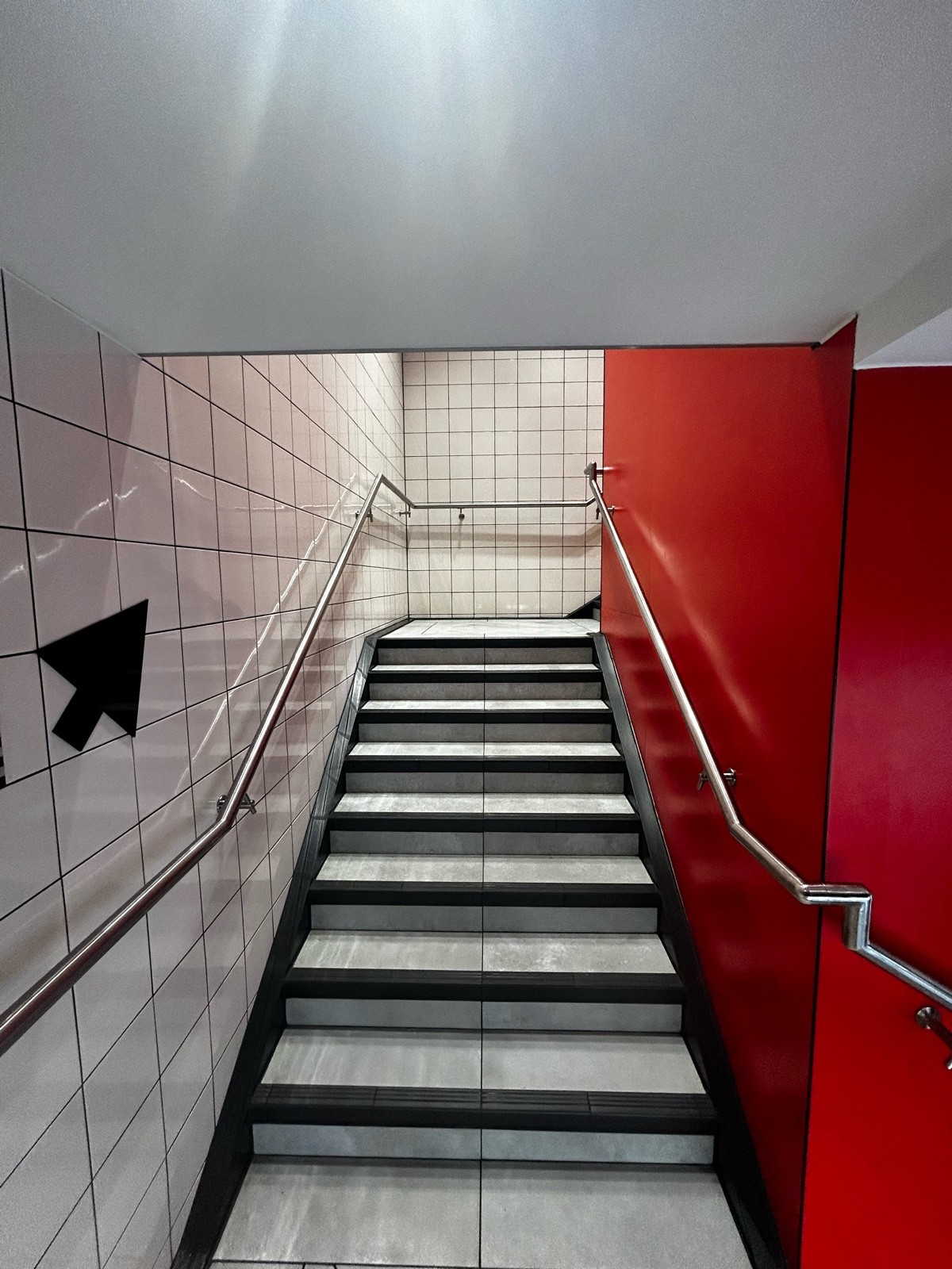 From first landing area, facing right. Stairs ahead leading to second landing area. Handrails on both sides