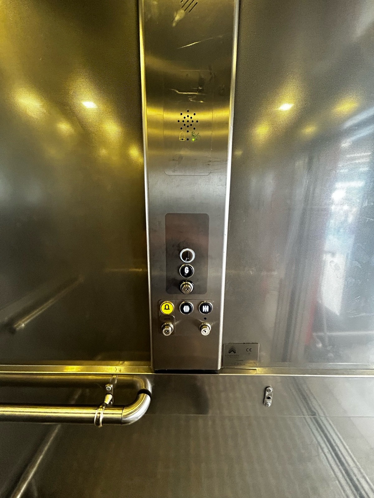 From inside the lift, facing right. Buttons ahead. Press 1 to get to upstairs.