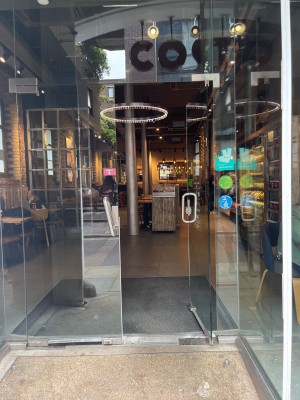 Double glass doors. Push silver metal doors from centre to open.