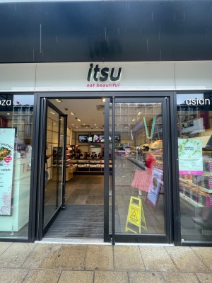 Double glass door with black frame. Push black vertical handle from middle to open.