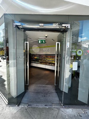 Double glass door with silver handles on middle. Push to open