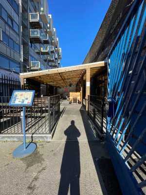 Built-in ramp ahead, sloping up. Black metal handrails along left and right.