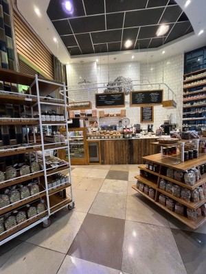 Facing main entrance. No formal door ahead. Path proceeds between display shelves to main areas.