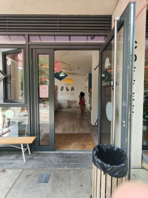 Black framed glass doors. Pull silver handle on left of right door to open.