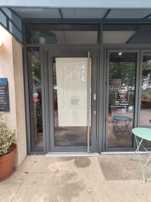 Grey framed glass door. Pull silver handle on right to open.
