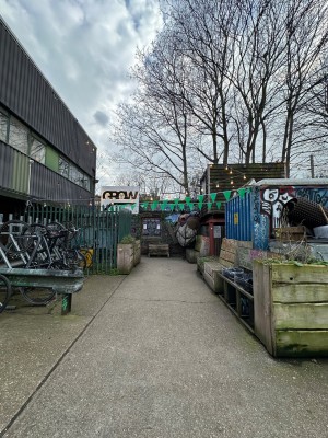 From pavement looking straight. Path goes straight towards fenced area.