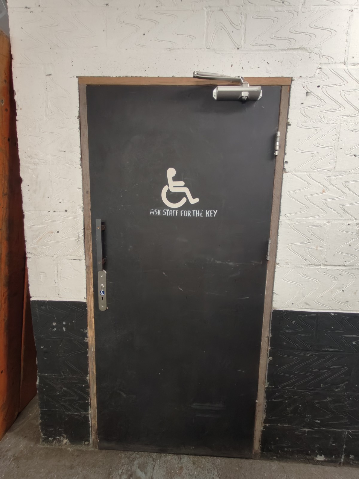 From end of path facing left. Black toilet door ahead. Use radar key on left to pull black handle above it to open.