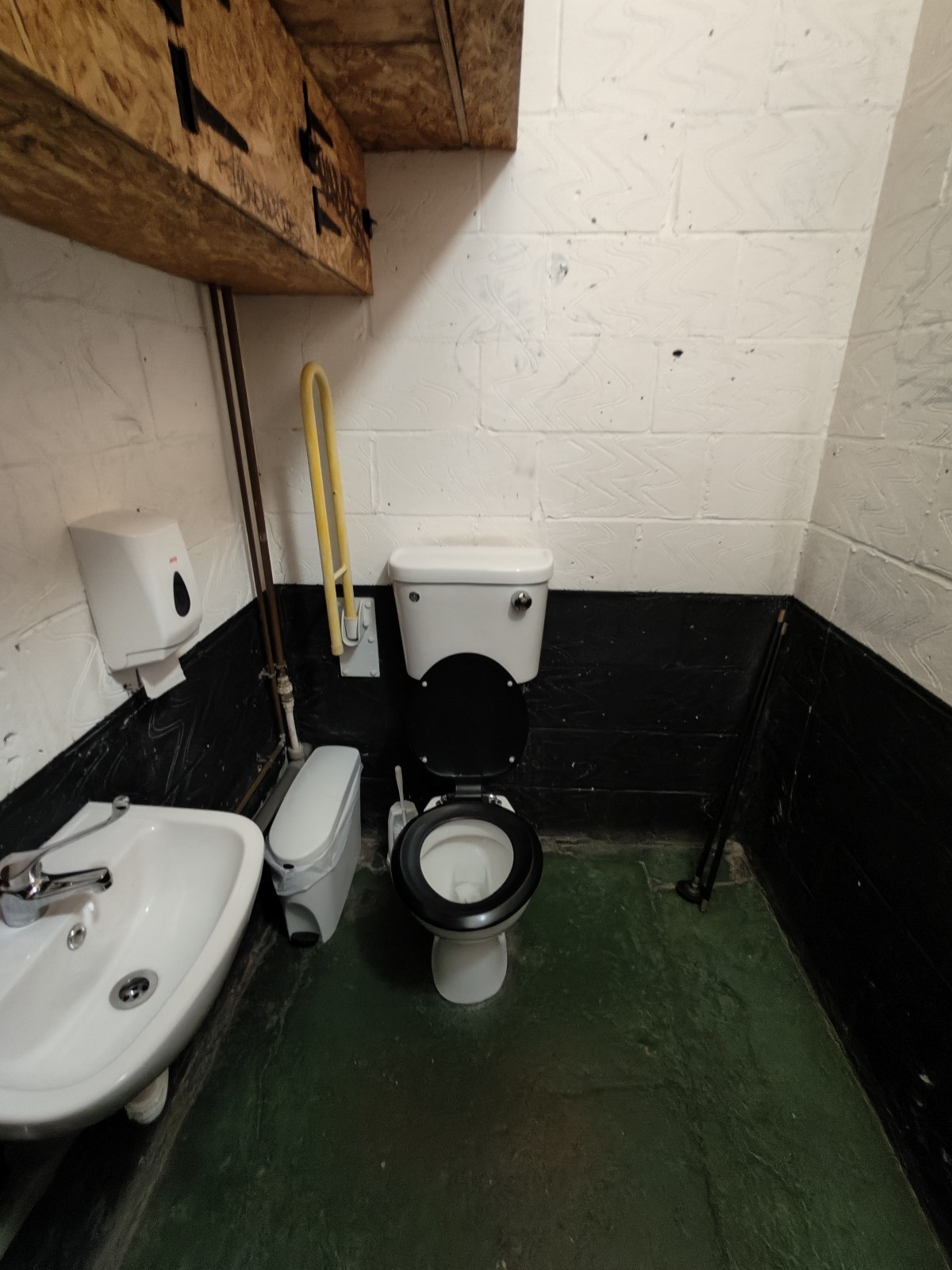 For. door facing right. Sink on left. Toilet at back left.