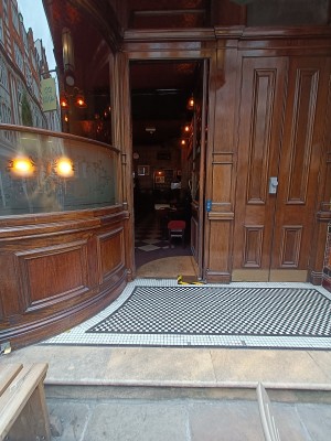 From street facing venu, step up to doorway. Door at back.