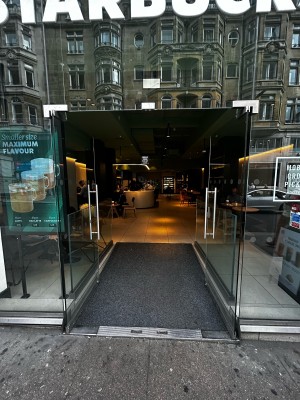 Double glass door with silver handles on mid. Push to open