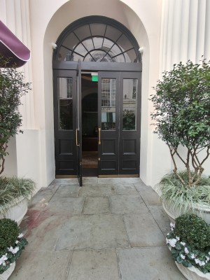 Black framed glass doors. Pull golden metal handles in centre to open.