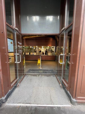 Double glass door with glass frame. Pull metal handles from middle to open.