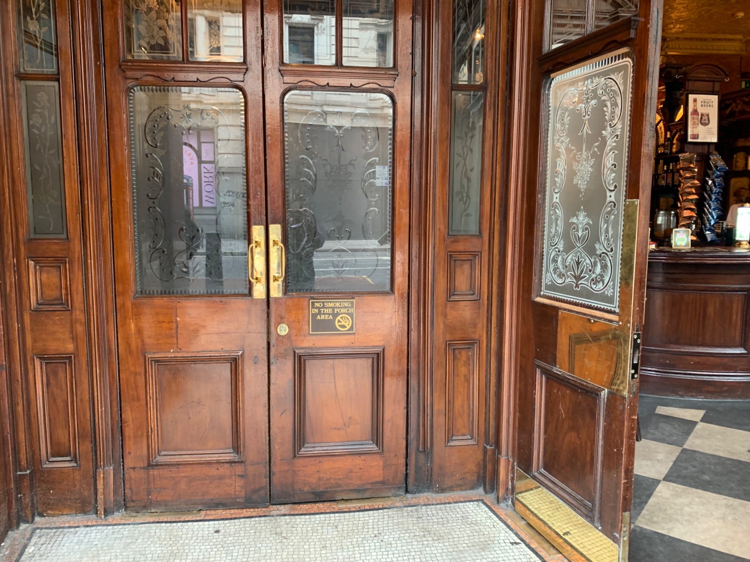 From entrance doorway, looking straight. Left foyer ahead. Doorway to left side area at back wall. Doorway to main area on right wall.