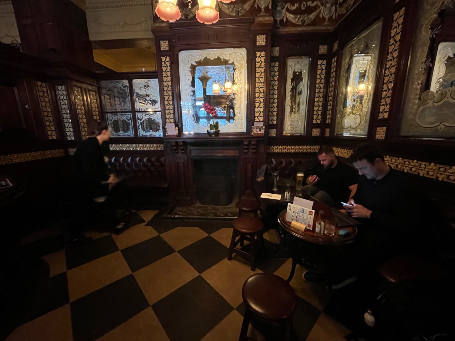 From door facing straight. Half booths along right wall and at back left.