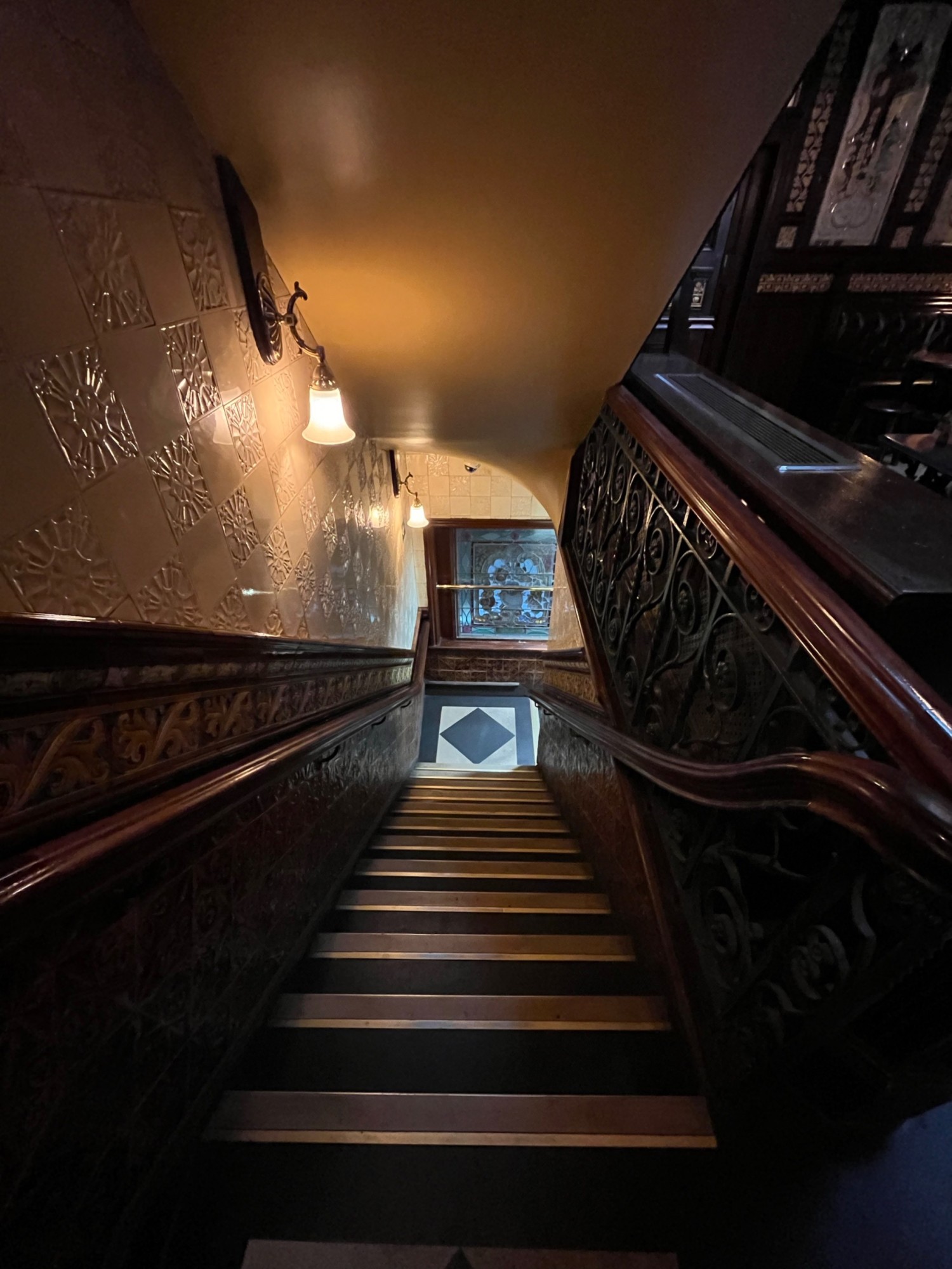 From end of path facing right. Staircase downstairs ahead leading to landing.