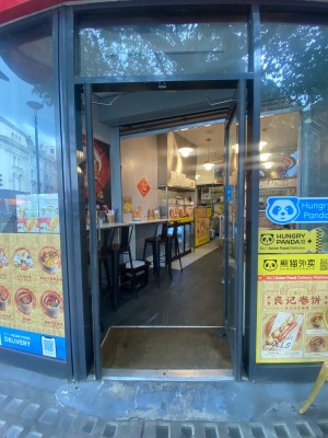 Double glass door, with black doorframe. Handles at centre of door. Push to open.