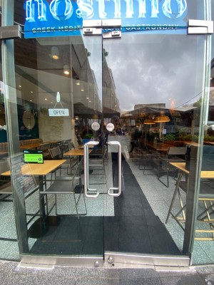 Double glass door, silver handles at centre. Push to open.