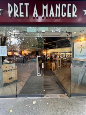 Glass doors with silver vertical handles in centre of doors. Push to open.