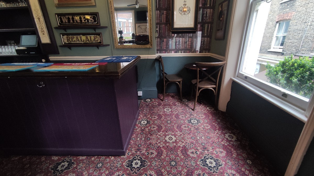 From end of counter facing left. Path ahead. Table and chairs at the back right of it.