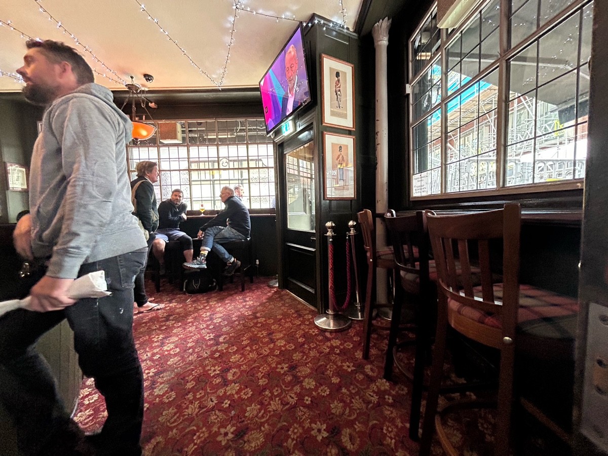 From alt entrance facing right. High table and stools right, main entrance back right. Bar left. Path middle to high table and stools at back.