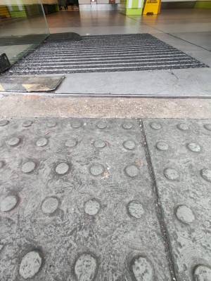 Raised edge on threshold of door.