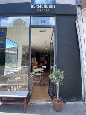 Glass door. Black vertical handle along left. Push to open.