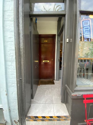 First grey door ahead. Push from right to open.