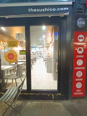 Glass door with black frame. Black, metal handle on right. Push to open.
