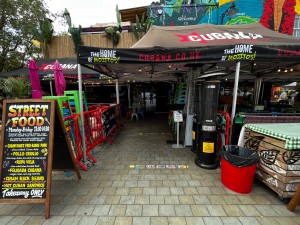 Market stall archway leading to main entrance door from street. Path continues slightly to right.
