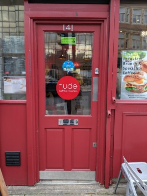 Glass door with wooden frame. Push from right to open.