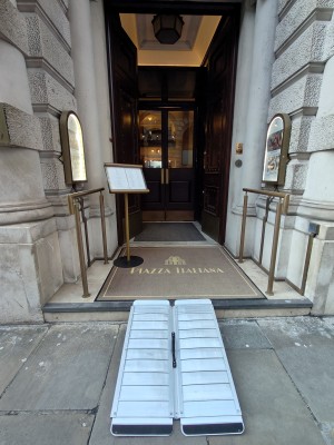 Facing opening to entrance. Ramp on request before first set of doors. Golden handrails on both sides.
