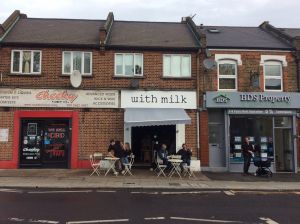 Cosy neighborhood coffee shop, nice outdoor space, adequate table height, has a step at the front door.