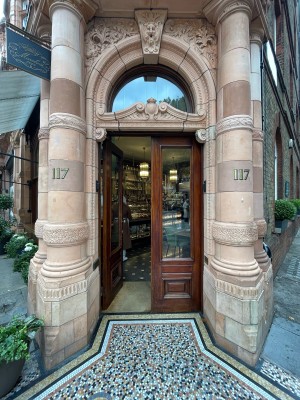 Double glass door with wooden frame. Push from centre to open.